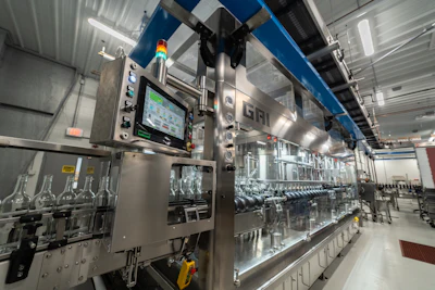 Shown here are bottles as they enter the monoblock rinser/filler/closer.