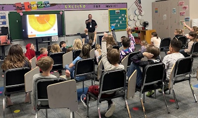 Kevin Pittner teaches second- and third-grade students about the lifecycle of trees.