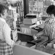 A customer checks out in the 1970s.