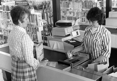 A customer checks out in the 1970s.