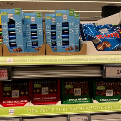 Ritter Sport chocolates on the shelf, several with their characteristic square shape. The brand brought Dalim software, and packaging asset library management and editing, in-house.