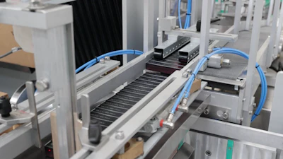 The first layer of 24 cartoned mascara tubes drops to make room the second layer. Once the 10th layer is added, a 240-ct cubic block is formed.