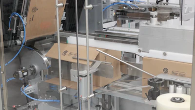 Side-load case packing happens after the case is erected and bottom flaps are tapled closed. Once packed with 240 cartons, the top flaps are closed and the finished cases leave the line. Palletizing is manual at this pace.