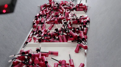 Brush, wand, and cap assemblies enter the filling and closing monoblock.