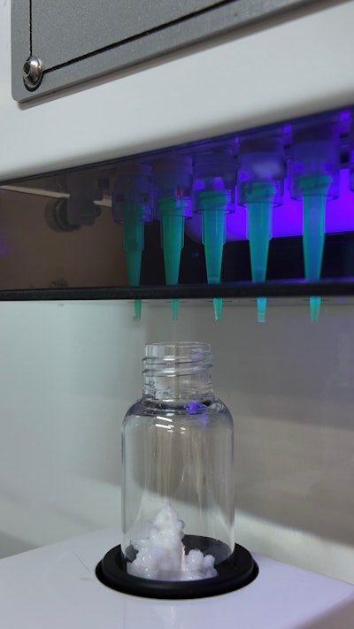 Filling nozzles deposit personalized combinations of specialty-formula skincare creams, mixing them into a single PET bottle.