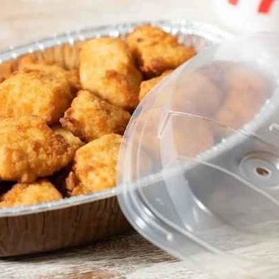 Chick-fil-A's football-shaped catering trays offer convenience with a playful theme for sports watchers.