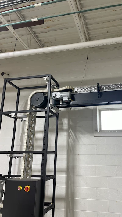 Once in the packaging hall, cans are lowerated from mezzanine level to floor height.