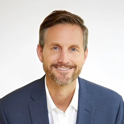 Smiling professional man in blue suit and white shirt with beard