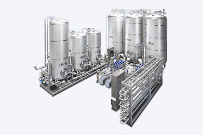 Stainless steel industrial processing system with multiple storage tanks and piping
