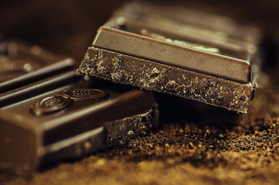 Dark chocolate bars stacked with golden crumbly edges