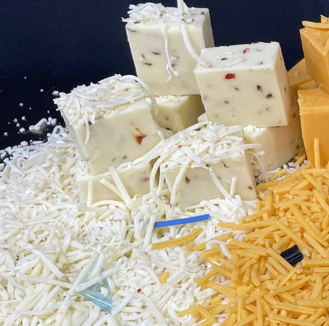 Assorted cheese varieties: white block cheese and shredded white and yellow cheese