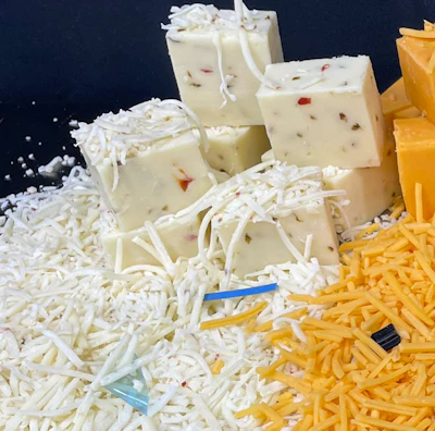 Assorted cheese varieties: white block cheese and shredded white and yellow cheese