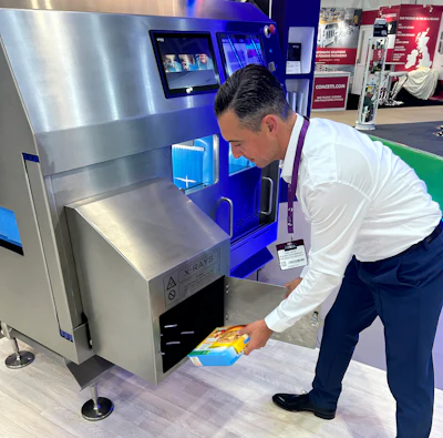 X-ray security scanner at trade show with technician scanning packaged item