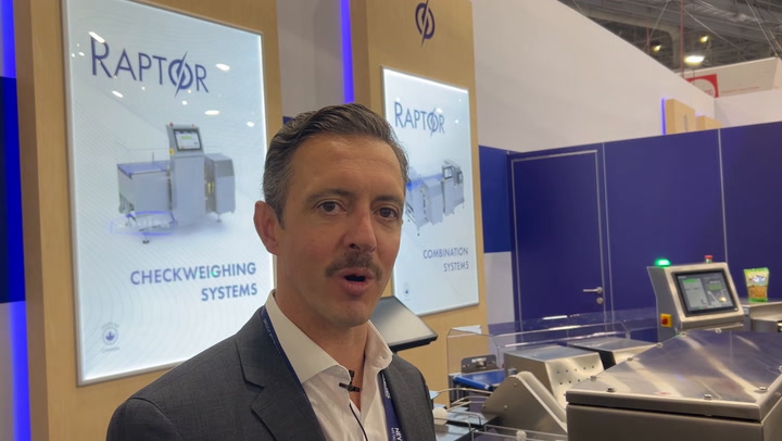 Professional presenting Raptor checkweighing system at industrial equipment exhibition