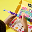 The packaging design for the Build-A-Brush encourages play, and is also scalable for future starter kits, brush heads, and expansion packs.