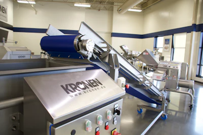 Industrial food processing machine with Kronen branding in commercial kitchen setting