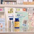 Health and wellness products including blood pressure monitor, adhesive bandages, and supplements