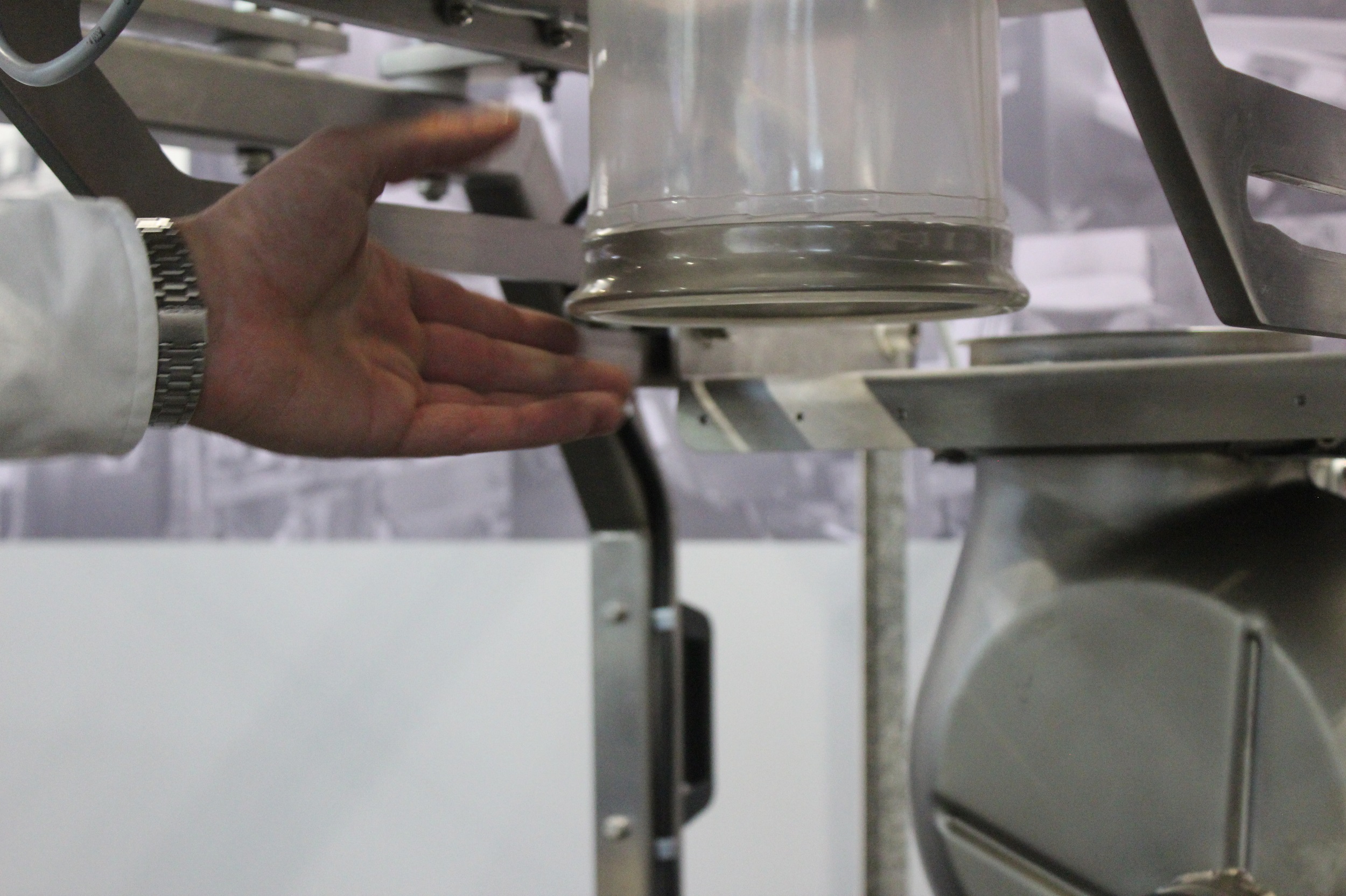 Hand adjusting metal equipment in scientific or industrial setting