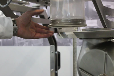 Hand adjusting metal equipment in scientific or industrial setting