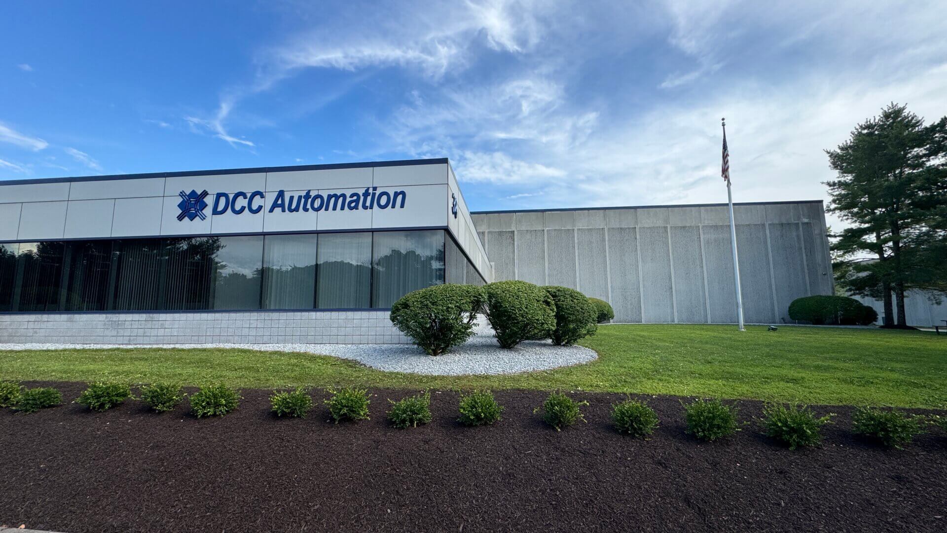 DCC Automation corporate building with landscaped grounds and blue sky