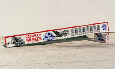 The multi-pack features an extended illustrated design covering the entire outer case, incorporating characters from the Godzilla franchise.