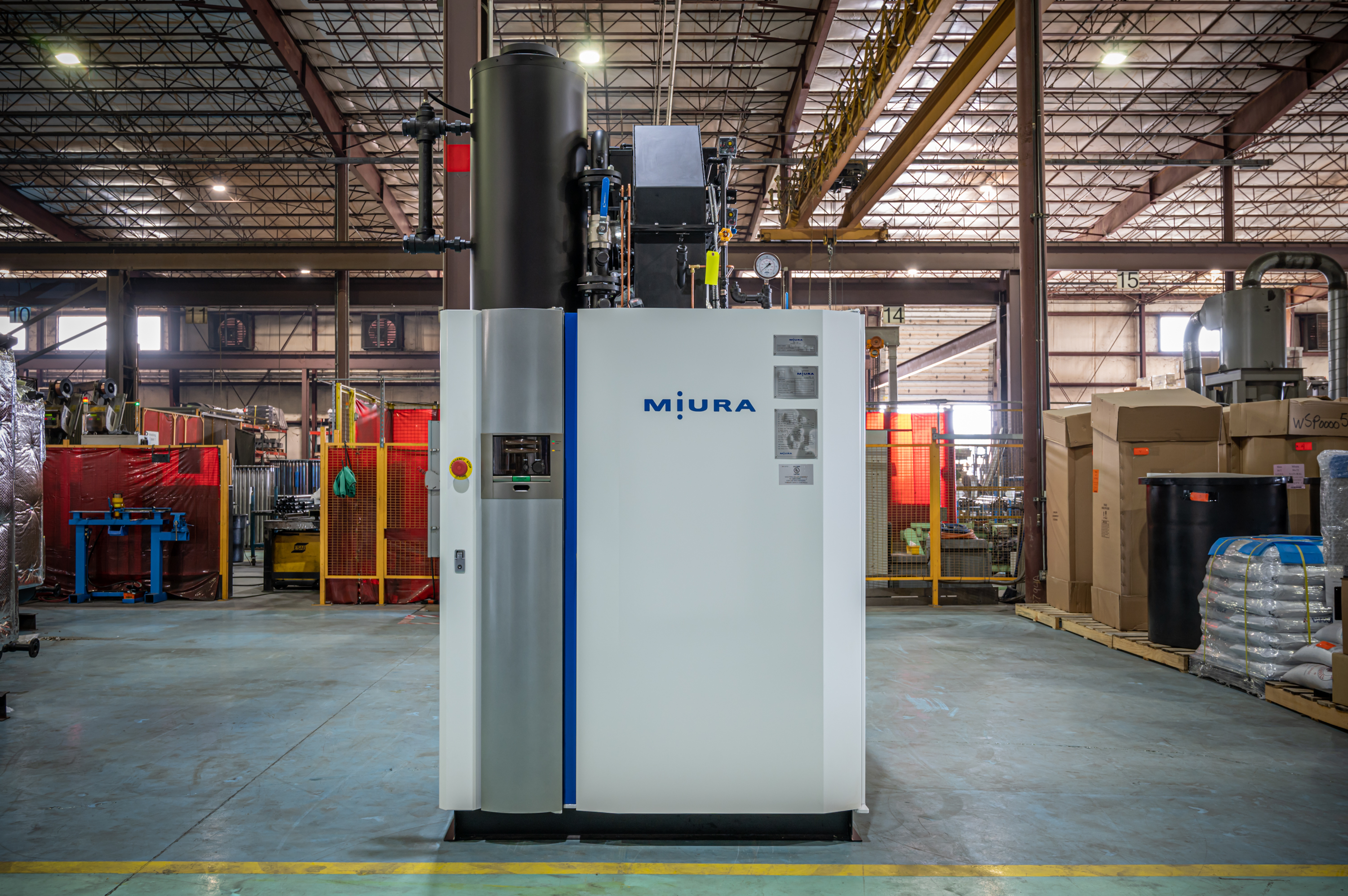 Miura industrial boiler system in factory warehouse with metal framework and equipment