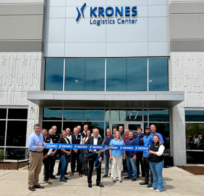 KRONES Logistics Center building with staff and executives at ribbon-cutting ceremony