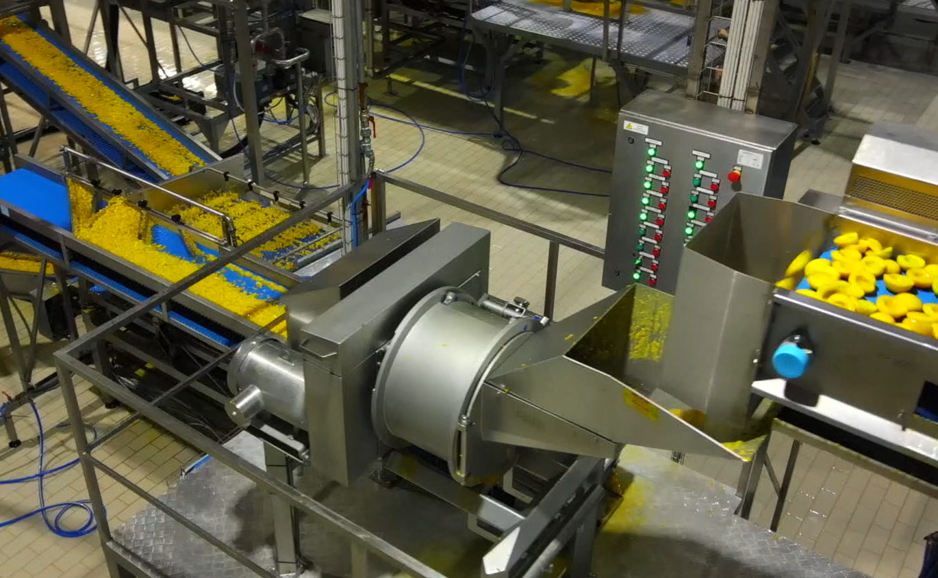 Industrial manufacturing facility with conveyor system, control panel, and yellow product bins