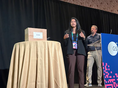 Auburn University's Soundarya Korlapati (center) and GS1's Jon Gregory demo Project Brilliance live at GS1 Connect 2026, scanning a pilot carton to check its contents against what the brand owner packed.