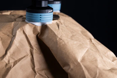Digital measuring tool with stacked blue calibration discs on wrinkled tan material