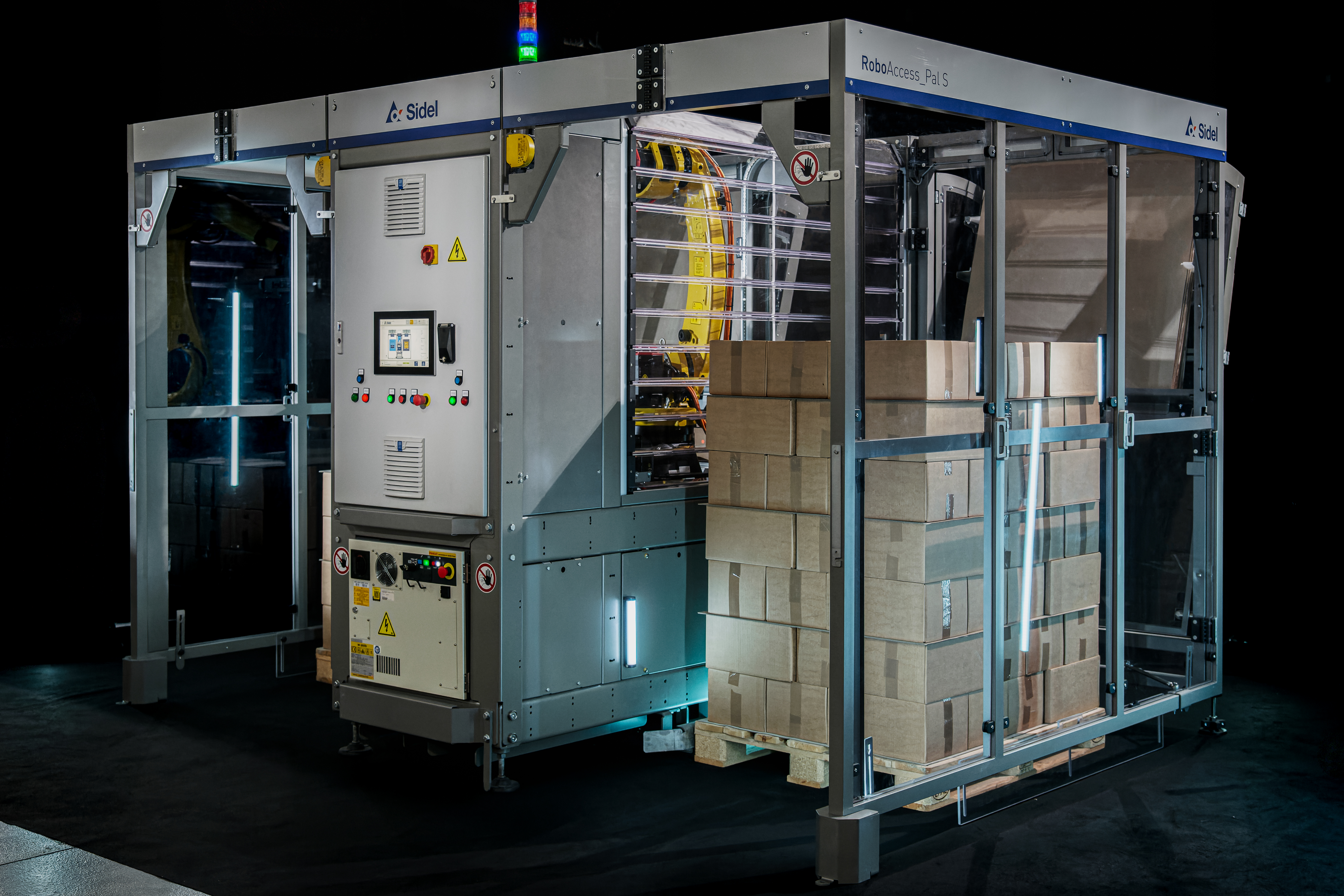 Industrial automated packaging machine with blue frame, control panels, and cardboard boxes on conveyor system