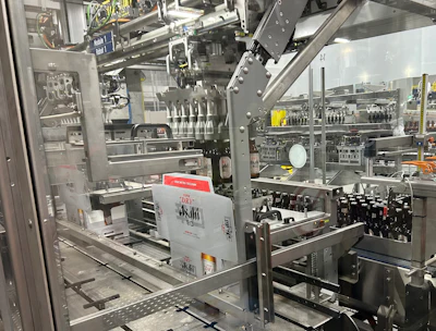 One of two robotic pickers responsible for picking bottles from a four-lane infeed conveyor and placing them into paperboard carriers that are already inside their corrugated cases
