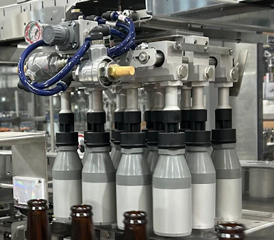 Robotic tooling that would be used if 21-oz bottles were in production. 12-oz bottles were on the line at the time of PW's visit.