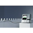 2D JET medical analyzer device with touchscreen display and sample bottles on gray background