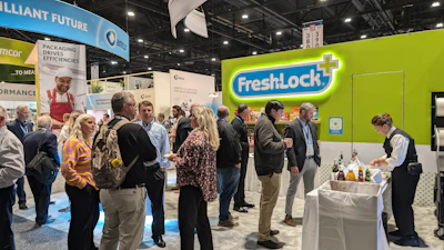FreshLock brand booth at trade show with attendees gathered around lime green signage and product display table