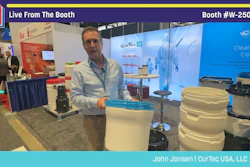 Man presenting CurTec USA products at Pack Expo booth W-25056, displaying storage containers and equipment