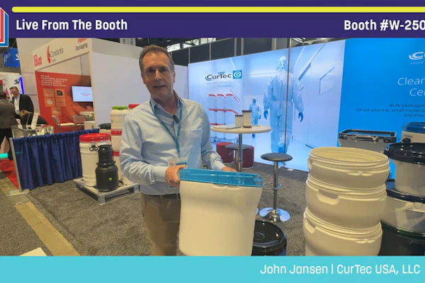 Man presenting CurTec USA products at Pack Expo booth W-25056, displaying storage containers and equipment