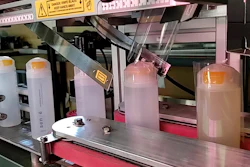 3D printer setup with supply bottles and industrial equipment on red platform
