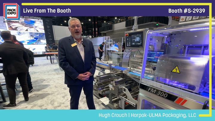 Professional demonstrating FM 300 packaging machinery at Pack Expo booth S-2939