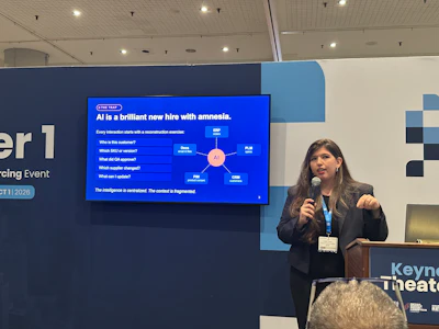 Professional woman presenting at conference with AI diagram on screen behind podium