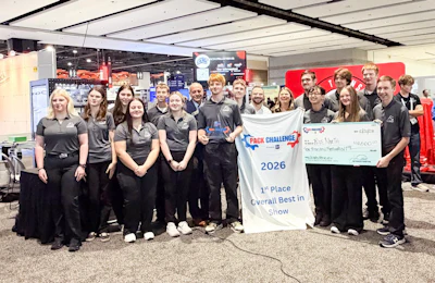 Team members in black uniforms celebrate first place at PACK Challenge 2026 robotics competition with banner.