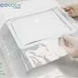 Hands opening Ecovate certified recyclable white packaging material by Nolipak
