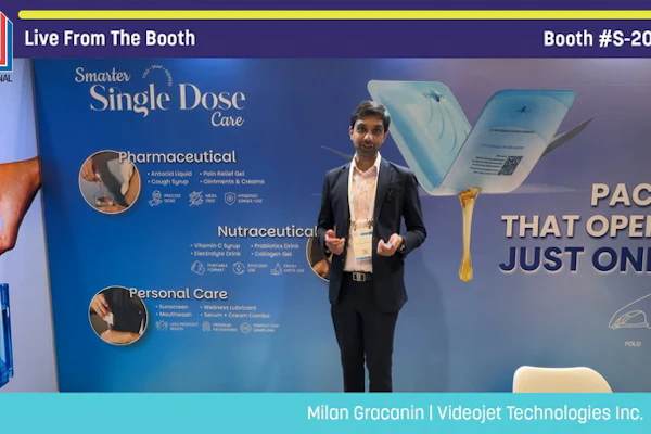 Presenter demonstrating single-dose pharmaceutical packaging at Pack Expo booth S-2042
